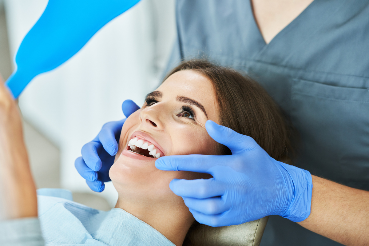 Dentist examining patient's teeth during routine dental checkup in La Jolla.